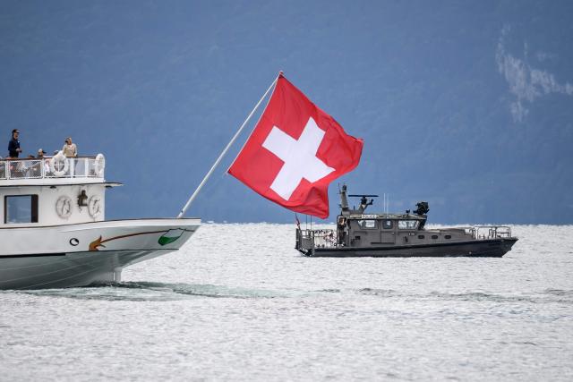 A Swiss military boat patrols Lake Geneva alongside a commercial vessel of the General Navigation Company on Lake Geneva (CGN) ahead of the upcoming G7 summit in nearby Evian, in Lausanne, on June 10, 2026. (Photo by Fabrice COFFRINI / AFP)