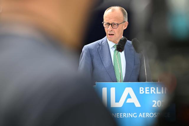 German Chancellor Friedrich Merz adresses the audience in front of an Airbus A320 Neo during the opening ceremony of the International Aerospace Exhibition (ILA) in Schoenefeld, near Berlin on June 10, 2026. (Photo by RALF HIRSCHBERGER / AFP)