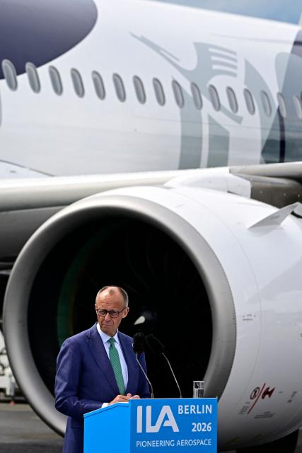 German Chancellor Friedrich Merz adresses the audience in front of an Airbus A320 Neo during the opening ceremony of the International Aerospace Exhibition (ILA) in Schoenefeld, near Berlin on June 10, 2026. (Photo by Tobias SCHWARZ / AFP)