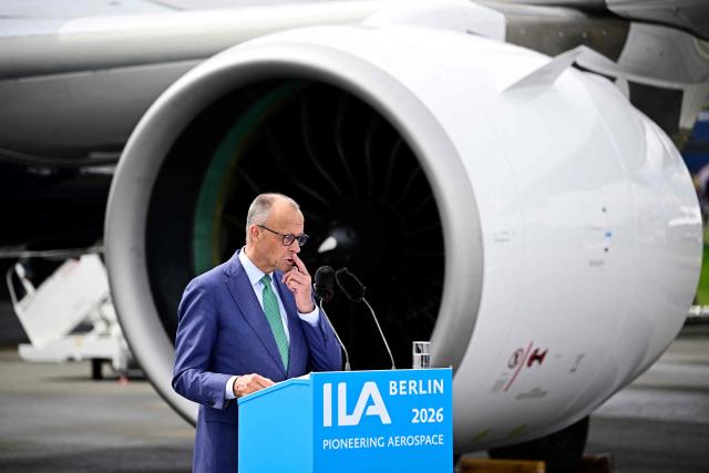 German Chancellor Friedrich Merz gestures as he adresses the audience in front of an Airbus A320 Neo during the opening ceremony of the International Aerospace Exhibition (ILA) in Schoenefeld, near Berlin on June 10, 2026. (Photo by Tobias SCHWARZ / AFP)