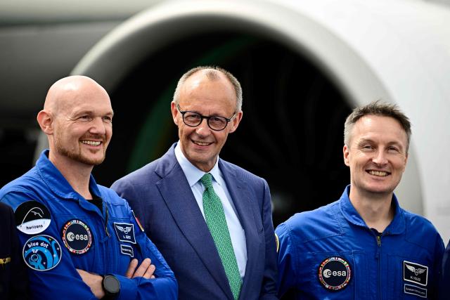 German Chancellor Friedrich Merz jokes with Alexander Gerst (L) and Matthias Maurer, astronauts of the European Space Agency (ESA) during the opening day of International Aerospace Exhibition (ILA) in Schoenefeld, near Berlin on June 10, 2026. (Photo by Tobias SCHWARZ / AFP)