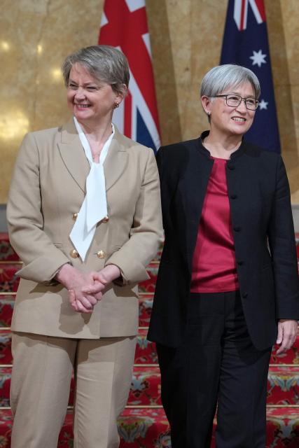 Britain's Foreign Secretary Yvette Cooper (L) and Australia’s Minister for Foreign Affair Penny Wong react as they pose for a photo during the annual Australia-UK Ministerial Consultations (AUKMIN) meeting in London on June 10, 2026. (Photo by Kin Cheung / POOL / AFP)