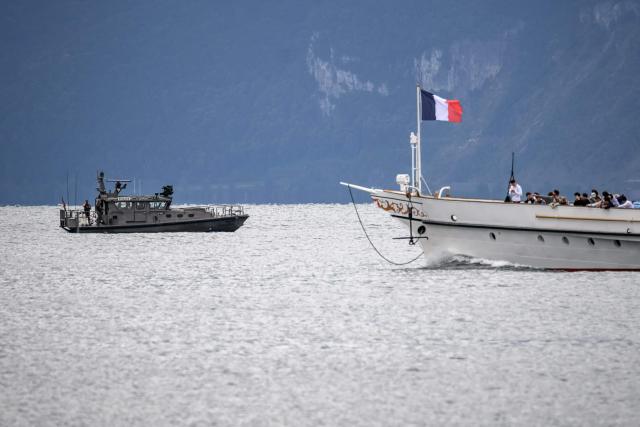 A Swiss military boat patrols Lake Geneva alongside a commercial vessel of the General Navigation Company on Lake Geneva (CGN) ahead of the upcoming G7 summit in nearby Evian, in Lausanne, on June 10, 2026. (Photo by Fabrice COFFRINI / AFP)