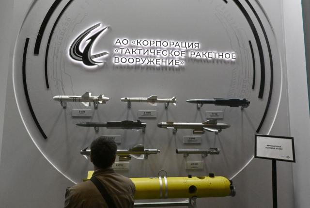 A visitor inspects models of various rockets and missiles during the International Maritime Defence Show "Fleet" 2026 in Kronstadt on June 10, 2026. (Photo by Olga MALTSEVA / AFP)