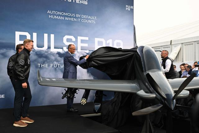 German Chancellor Friedrich Merz attends the unveiling of the PULSE P19 drone, manufactured by German manufacturer of civil and military surveillance drones Quantum-Systems, during his visit at the International Aerospace Exhibition (ILA) in Schoenefeld, near Berlin on June 10, 2026. (Photo by RALF HIRSCHBERGER / AFP)