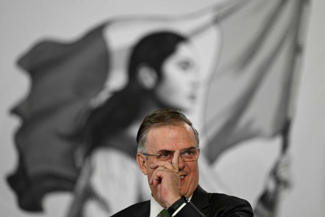 Mexico's Secretary of Economy Marcelo Ebrard gesturs as Mexico's President Claudia Sheinbaum speaks during her daily press conference at Palacio Nacional in Mexico City on June 10, 2026. (Photo by Yuri CORTEZ / AFP)