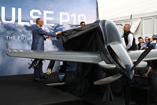 German Chancellor Friedrich Merz attends the unveiling of the PULSE P19 drone, manufactured by German manufacturer of civil and military surveillance drones Quantum-Systems, during his visit at the International Aerospace Exhibition (ILA) in Schoenefeld, near Berlin on June 10, 2026. (Photo by RALF HIRSCHBERGER / AFP)