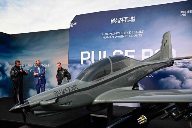 German Chancellor Friedrich Merz (C) attents the unveiling of the PULSE P19 drone manufactured by German manufacturer of civil and military surveillance drones Quantum-Systems during his visit at the International Aerospace Exhibition (ILA) in Schoenefeld, near Berlin on June 10, 2026. (Photo by Tobias SCHWARZ / AFP)