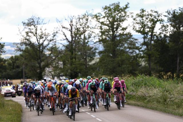 The pack of riders (peloton) cycles during the 4th stage of the Tour Auvergne-Rhone-Alpes cycling race (formerly known as the Criterium du Dauphine), 167,4km between Le Puy-en-Velay and Montrond-les-Bains, central France, on June 10, 2026. (Photo by Anne-Christine POUJOULAT / AFP)