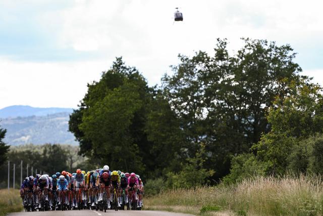 The pack of riders (peloton) cycles during the 4th stage of the Tour Auvergne-Rhone-Alpes cycling race (formerly known as the Criterium du Dauphine), 167,4km between Le Puy-en-Velay and Montrond-les-Bains, central France, on June 10, 2026. (Photo by Anne-Christine POUJOULAT / AFP)