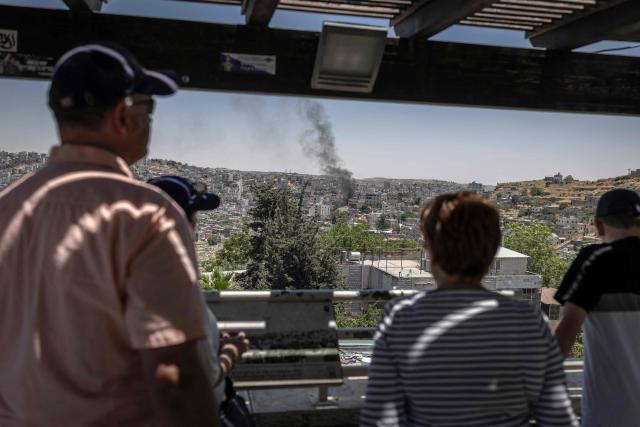 American tourists look on from a viewpoint in Hebron, in the Israeli occupied West Bank on June 10, 2026. Israel has occupied the West Bank since 1967, and violence has sharply escalated in the Palestinian territory since the Gaza war began in 2023. (Photo by ilia YEFIMOVICH / AFP)