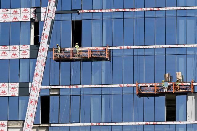 Men work at an under-construction building in Islamabad on June 10, 2026. (Photo by Farooq NAEEM / AFP)