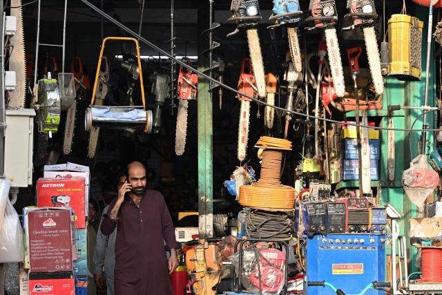 A customer walks out a hardware store at a market in Rawalpindi on June 10, 2026. (Photo by Farooq NAEEM / AFP)