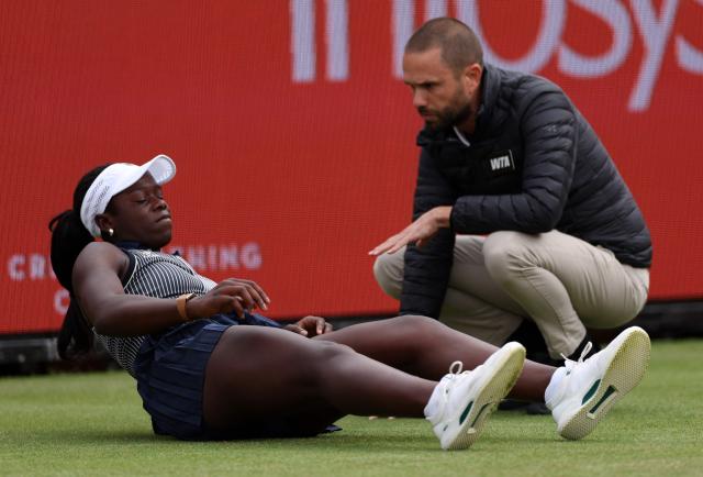 Canada's Victoria Mboko reacts after slipping on the grass attempting to play a return shot against Czech Republic's Karolina Pliskova during their round of 16 women's singles match at the HSBC WTA tennis Championships at Queen's Club in west London on June 10, 2026. Pliskova won the match 6-2, 3-4 after Mboko retired in the second set. (Photo by Adrian Dennis / AFP)