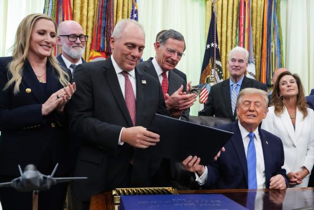 US President Donald Trump hands a copy of the bill to House Majority Leader Steve Scalise, Republican from Louisiana, during a signing ceremony for the "Secure America Act" in the Oval Office of the White House in Washington, DC, on June 10, 2026. The bill provides around $38 billion for Immigration and Customs Enforcement (ICE), $26 billion for Border Patrol and another $5 billion for unforeseen costs, effectively ensuring a steady flow of money for Trump's deportation agenda through fiscal 2029. (Photo by Ken Cedeno / AFP)