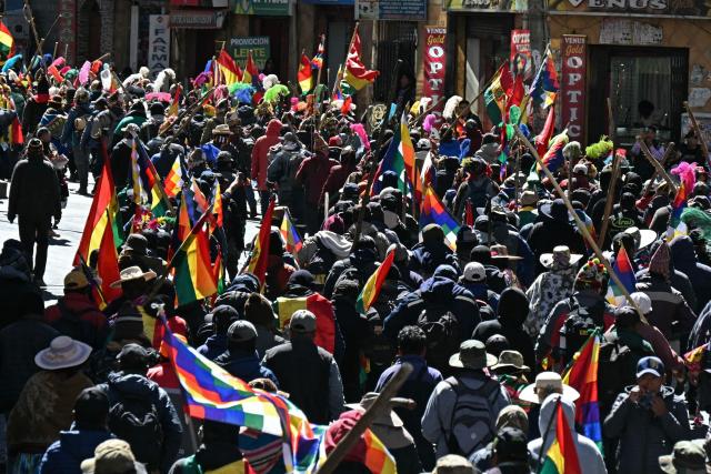 Demonstrators carrying flags and wooden sticks march to protest against the government of Bolivia's President Rodrigo Paz in La Paz on June 10, 2026. For weeks, protesters demanding that US-backed conservative President Rodrigo Paz's fledgling government address a deep economic crisis, while others called for his resignation, have marched and set up roadblocks, bringing Bolivia to a near standstill, driving up food and fuel prices and causing shortages of basic goods. (Photo by AIZAR RALDES / AFP)