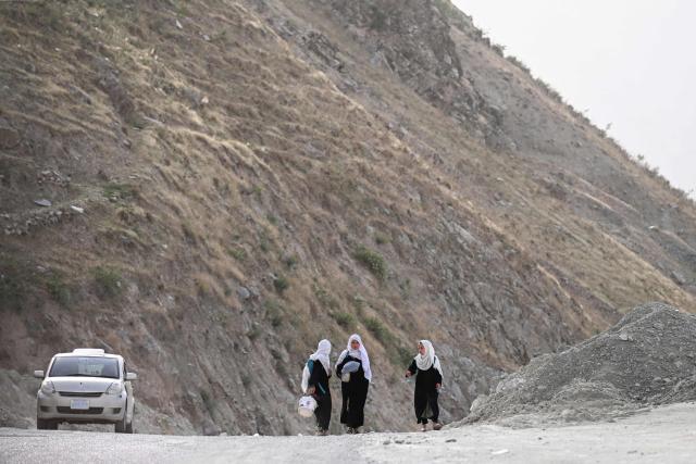 Afghan school girls walk along a hillside in Argo district, Badakhshan province on June 10, 2026. (Photo by OMER ABRAR / AFP)