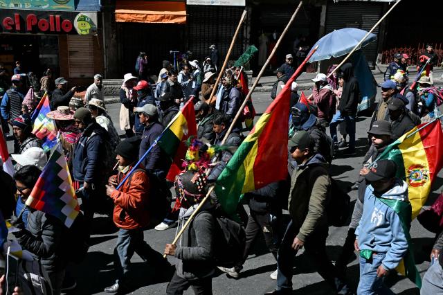 Demonstrators carrying flags and wooden sticks march to protest against the government of Bolivia's President Rodrigo Paz in La Paz on June 10, 2026. For weeks, protesters demanding that US-backed conservative President Rodrigo Paz's fledgling government address a deep economic crisis, while others called for his resignation, have marched and set up roadblocks, bringing Bolivia to a near standstill, driving up food and fuel prices and causing shortages of basic goods. (Photo by AIZAR RALDES / AFP)
