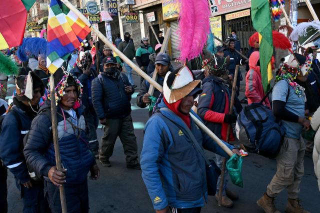 A demonstrator carrying a Wiphala flag marches during a protest against the government of Bolivia's President Rodrigo Paz in La Paz on June 10, 2026. For weeks, protesters demanding that US-backed conservative President Rodrigo Paz's fledgling government address a deep economic crisis, while others called for his resignation, have marched and set up roadblocks, bringing Bolivia to a near standstill, driving up food and fuel prices and causing shortages of basic goods. (Photo by AIZAR RALDES / AFP)