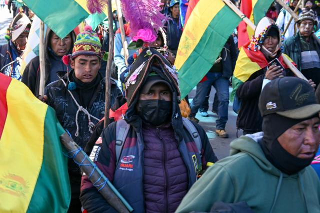 Demonstrators carrying flags and wooden sticks march to protest against the government of Bolivia's President Rodrigo Paz in La Paz on June 10, 2026. For weeks, protesters demanding that US-backed conservative President Rodrigo Paz's fledgling government address a deep economic crisis, while others called for his resignation, have marched and set up roadblocks, bringing Bolivia to a near standstill, driving up food and fuel prices and causing shortages of basic goods. (Photo by AIZAR RALDES / AFP)