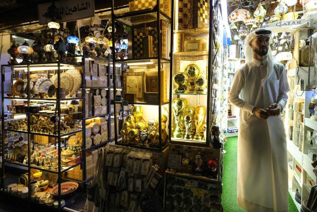 A man stands at a shop displaying replicas of the World Cup trophy at Souq Waqif in Doha on June 10, 2026. At the World Cup 2026, Qatar begin their Group B campaign against Switzerland on June 13 before facing Bosnia Herzegovina and co-hosts Canada in the pool stage. (Photo by Karim JAAFAR / AFP)