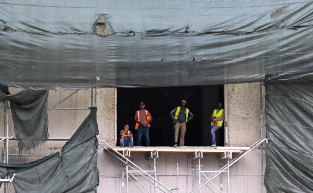 Construction workers take a break during a power cut in Havana on June 10, 2026. (Photo by YAMIL LAGE / AFP)