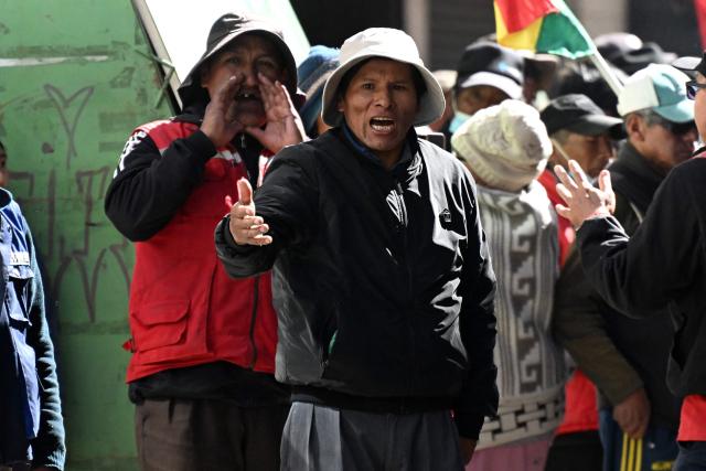 Demonstrators chant slogans near a burning object during a protest against the government of Bolivia's President Rodrigo Paz in La Paz on June 10, 2026. For weeks, protesters demanding that US-backed conservative President Rodrigo Paz's fledgling government address a deep economic crisis, while others called for his resignation, have marched and set up roadblocks, bringing Bolivia to a near standstill, driving up food and fuel prices and causing shortages of basic goods. (Photo by MARVIN RECINOS / AFP)