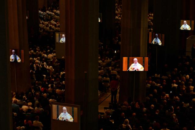 Pope Leo XIV is seen on giant screens during a holy mass in the Basilica of the Sagrada Familia in Barcelona, on June 10, 2026. Pope Leo XIV is visiting Spain June 6-12 with stops in Madrid, Barcelona, and the Canary Islands, where he will meet with migrants and organisations dedicated to helping them. (Photo by Stefano RELLANDINI / AFP)