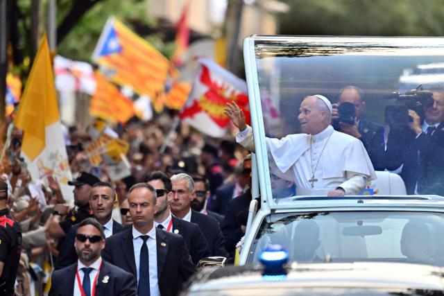 Pope Leo XIV waves as he arrives to lead Holy Mass in the Basilica of the Sagrada Familia and inauguration of the Jesus Christ tower in Barcelona, on June 10, 2026. Pope Leo XIV is visiting Spain June 6-12 with stops in Madrid, Barcelona, and the Canary Islands, where he will meet with migrants and organisations dedicated to helping them. (Photo by Manaure QUINTERO / AFP)