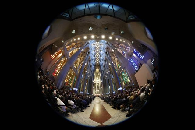 This picture taken with a fish-eye lense shows people attending Holy Mass led by Pope Leo XIV in the Basilica of the Sagrada Familia in Barcelona, on June 10, 2026. Pope Leo XIV is visiting Spain June 6-12 with stops in Madrid, Barcelona, and the Canary Islands, where he will meet with migrants and organisations dedicated to helping them. (Photo by Josep LAGO / AFP)