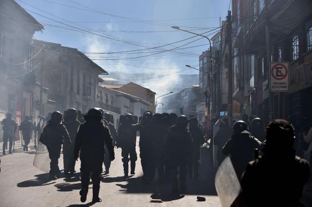 Riot police officers disperse demonstrators with tear gas during a protest against the government of Bolivia's President Rodrigo Paz in La Paz on June 10, 2026. For weeks, protesters demanding that US-backed conservative President Rodrigo Paz's fledgling government address a deep economic crisis, while others called for his resignation, have marched and set up roadblocks, bringing Bolivia to a near standstill, driving up food and fuel prices and causing shortages of basic goods. (Photo by Jorge BERNAL / AFP)
