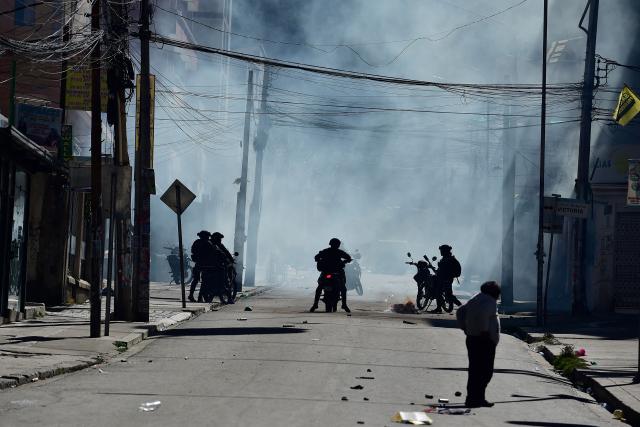 Riot police fire tear gas to disperse demonstrators during a protest against the government of Bolivia's President Rodrigo Paz in La Paz on June 10, 2026. For weeks, protesters demanding that US-backed conservative President Rodrigo Paz's fledgling government address a deep economic crisis, while others called for his resignation, have marched and set up roadblocks, bringing Bolivia to a near standstill, driving up food and fuel prices and causing shortages of basic goods. (Photo by Jorge BERNAL / AFP)