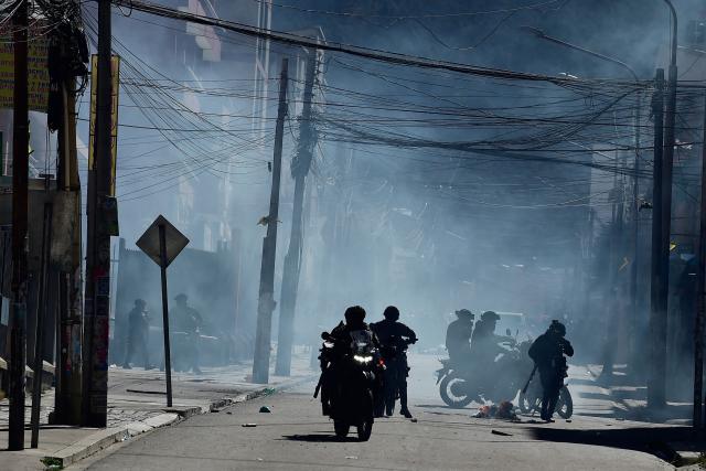 Police officers on motorcycles disperse demonstrators with tear gas during a protest against the government of Bolivia's President Rodrigo Paz in La Paz on June 10, 2026. For weeks, protesters demanding that US-backed conservative President Rodrigo Paz's fledgling government address a deep economic crisis, while others called for his resignation, have marched and set up roadblocks, bringing Bolivia to a near standstill, driving up food and fuel prices and causing shortages of basic goods. (Photo by Jorge BERNAL / AFP)