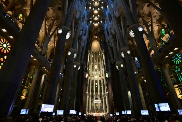 Pope Leo XIV leading a Holy Mass is seen on screens in the Basilica of the Sagrada Familia and the inauguration of the Jesus Christ tower in Barcelona, on June 10, 2026. Pope Leo XIV is visiting Spain June 6-12 with stops in Madrid, Barcelona, and the Canary Islands, where he will meet with migrants and organisations dedicated to helping them. (Photo by Stefano RELLANDINI / AFP)