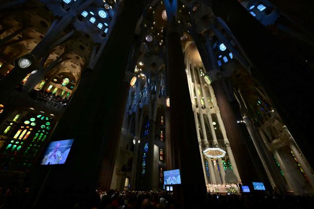 Pope Leo XIV is seen on giant screens during a holy mass in the Basilica of the Sagrada Familia in Barcelona, on June 10, 2026. Pope Leo XIV is visiting Spain June 6-12 with stops in Madrid, Barcelona, and the Canary Islands, where he will meet with migrants and organisations dedicated to helping them. (Photo by Stefano RELLANDINI / AFP)