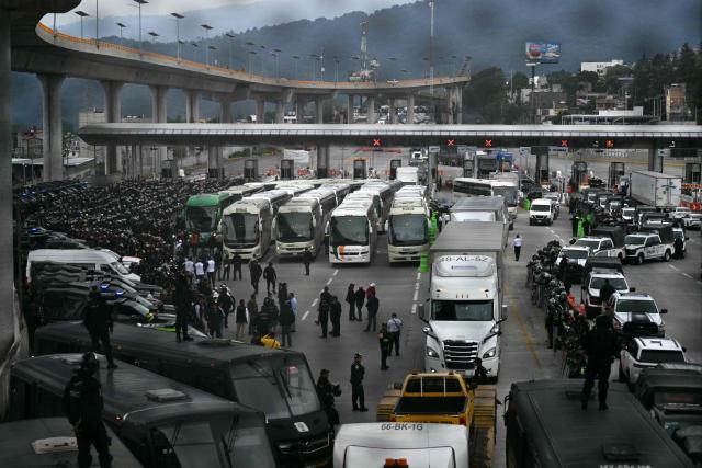 View during a police operation that keeps retained buses transporting students from Ayotzinapa who try to enter the city and join the protests of teachers and relatives of missing people ahead of the start of the 2026 FIFA World Cup, on the outskirts of Mexico City, on June 10, 2026. (Photo by YURI CORTEZ / AFP)