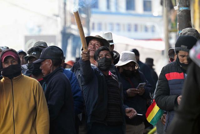 A demonstrator launches a pyrotechnic device during a protest against the government of Bolivia's President Rodrigo Paz in La Paz on June 10, 2026. For weeks, protesters demanding that US-backed conservative President Rodrigo Paz's fledgling government address a deep economic crisis, while others called for his resignation, have marched and set up roadblocks, bringing Bolivia to a near standstill, driving up food and fuel prices and causing shortages of basic goods. (Photo by MARVIN RECINOS / AFP)