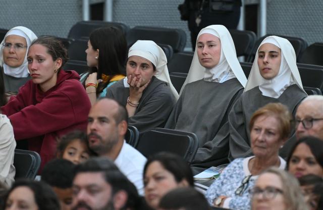 Nuns watch on a giant screen a Holy Mass led by Pope Leo XIV, outside of the Basilica of the Sagrada Familia, in Barcelona, on June 10, 2026. Pope Leo XIV is visiting Spain June 6-12 with stops in Madrid, Barcelona, and the Canary Islands, where he will meet with migrants and organisations dedicated to helping them. (Photo by JOSE JORDAN / AFP)