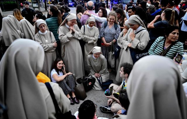 Nuns and people listen to the Holy Mass led by Pope Leo XIV outside of the Basilica of the Sagrada Familia in Barcelona, on June 10, 2026. Pope Leo XIV is visiting Spain June 6-12 with stops in Madrid, Barcelona, and the Canary Islands, where he will meet with migrants and organisations dedicated to helping them. (Photo by Ander Gillenea / AFP)