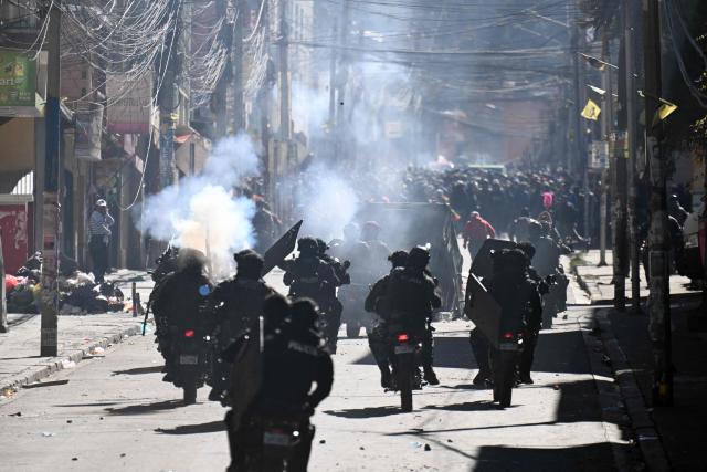 Police officers on motorcycles disperse demonstrators with tear gas during a protest against the government of Bolivia's President Rodrigo Paz in La Paz on June 10, 2026. For weeks, protesters demanding that US-backed conservative President Rodrigo Paz's fledgling government address a deep economic crisis, while others called for his resignation, have marched and set up roadblocks, bringing Bolivia to a near standstill, driving up food and fuel prices and causing shortages of basic goods. (Photo by MARVIN RECINOS / AFP)