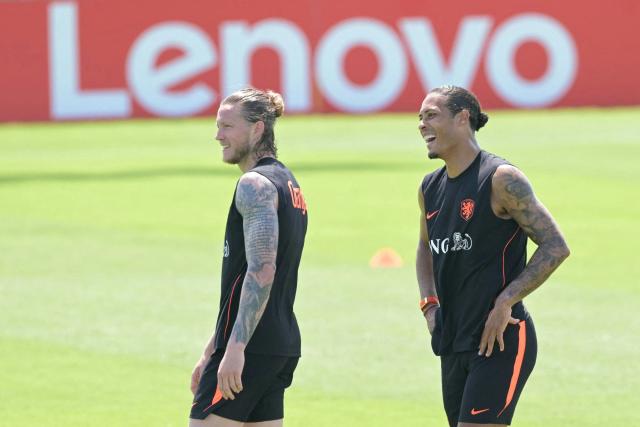 Netherlands' forward #09 Wout Weghorst (L) and defender #04 Virgil van Dijk smile during a training session at KC Current Training Facility in Kansas City on June 10, 2026, ahead of the 2026 World Cup football tournament. (Photo by JUAN MABROMATA / AFP)