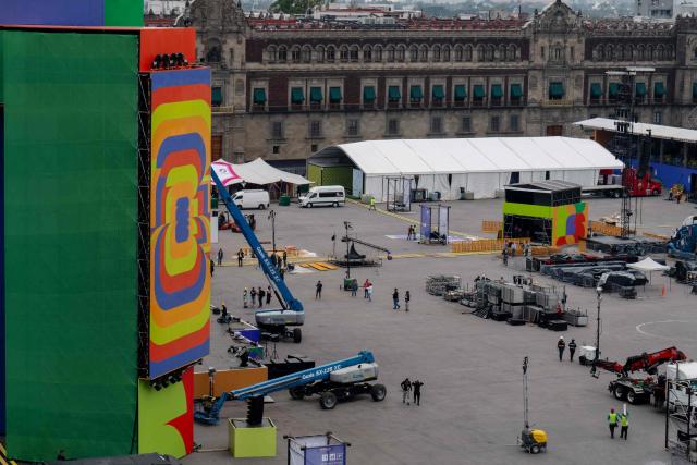 Workers set up the FIFA Fan Fest installations at Zocalo Square, one day before the opening of the 2026 FIFA World Cup football tournament in Mexico City on June 10, 2026. (Photo by Gerardo Luna / AFP)