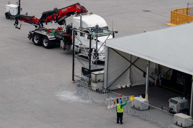 Workers set up the FIFA Fan Fest installations at Zocalo Square, one day before the opening of the 2026 FIFA World Cup football tournament in Mexico City on June 10, 2026. (Photo by Gerardo Luna / AFP)