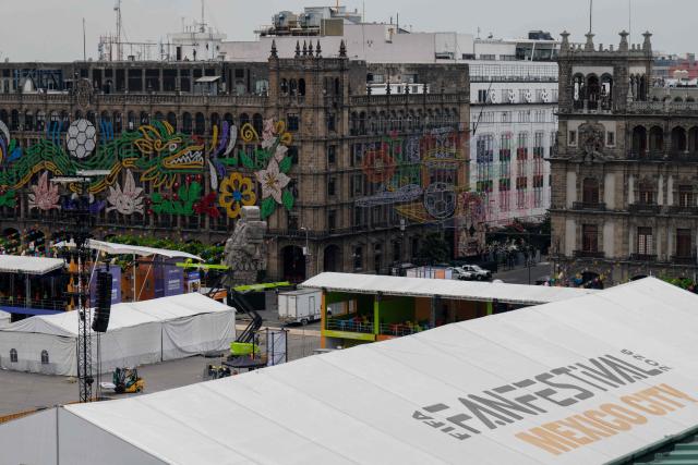 Workers set up the FIFA Fan Fest installations at Zocalo Square, one day before the opening of the 2026 FIFA World Cup football tournament in Mexico City on June 10, 2026. (Photo by Gerardo Luna / AFP)