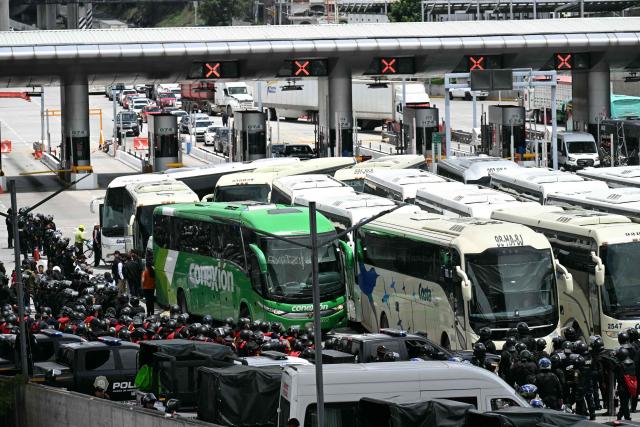 View during a police operation that keeps retained buses transporting students from Ayotzinapa who try to enter the city and join the protests of teachers and relatives of missing people ahead of the start of the 2026 FIFA World Cup, on the outskirts of Mexico City, on June 10, 2026. (Photo by YURI CORTEZ / AFP)