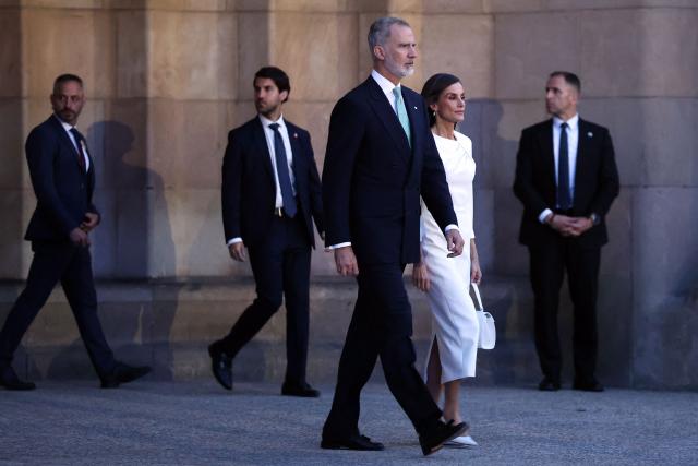 King Felipe VI (L) and Queen Letizia get out the Sagrada Famila Basilica to attend the inauguration of the temple's Jesus Christ tower by Pope Leo XIV in Barcelona, on June 10, 2026. Pope Leo XIV is visiting Spain June 6-12 with stops in Madrid, Barcelona, and the Canary Islands, where he will meet with migrants and organisations dedicated to helping them. (Photo by Josep LAGO / AFP)