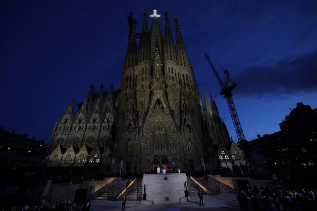 Pope Leo XIV (down) blesses Jesus Christ tower of the Sagrada Familia during its inauguration in Barcelona, on June 10, 2026. Pope Leo XIV is visiting Spain June 6-12 with stops in Madrid, Barcelona, and the Canary Islands, where he will meet with migrants and organisations dedicated to helping them. (Photo by Lluis GENE / AFP)