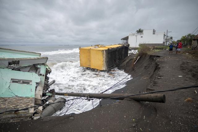 People look at the damage caused by rough seas ahead of the arrival of Storm Cristina in Iztapa, Guatemala on June 10, 2026. The countries of Central America remain on alert over the effects of Tropical Storm Cristina, which formed on June 8, 2026 in the Pacific Ocean, civil protection services reported. (Photo by Carlos ALONZO / AFP)