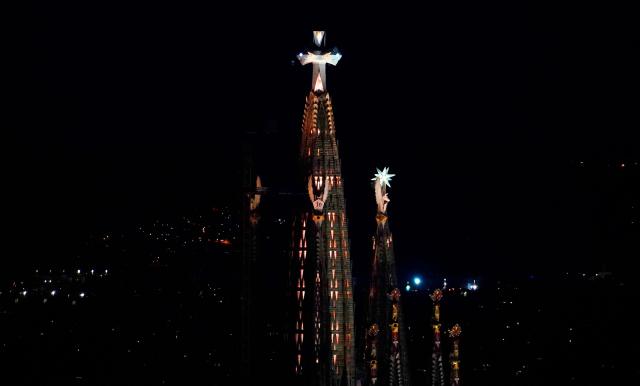 The Jesus Christ Tower of the basilica of the Sagrada Familia is illuminated after Pope Leo XIV blessed it during its inauguration in Barcelona, on June 10, 2026. Pope Leo XIV is visiting Spain June 6-12 with stops in Madrid, Barcelona, and the Canary Islands, where he will meet with migrants and organisations dedicated to helping them. (Photo by Manaure Quintero / AFP)