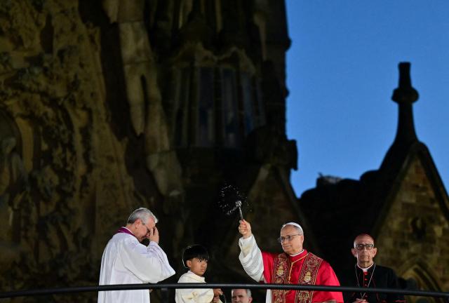 Pope Leo XIV blesses Jesus Christ tower of the Sagrada Familia during its inauguration in Barcelona, on June 10, 2026. Pope Leo XIV is visiting Spain June 6-12 with stops in Madrid, Barcelona, and the Canary Islands, where he will meet with migrants and organisations dedicated to helping them. (Photo by Stefano RELLANDINI / AFP)